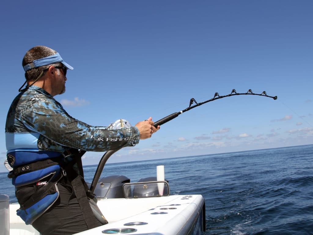 Angler fighting a fish while wearing a fighting belt