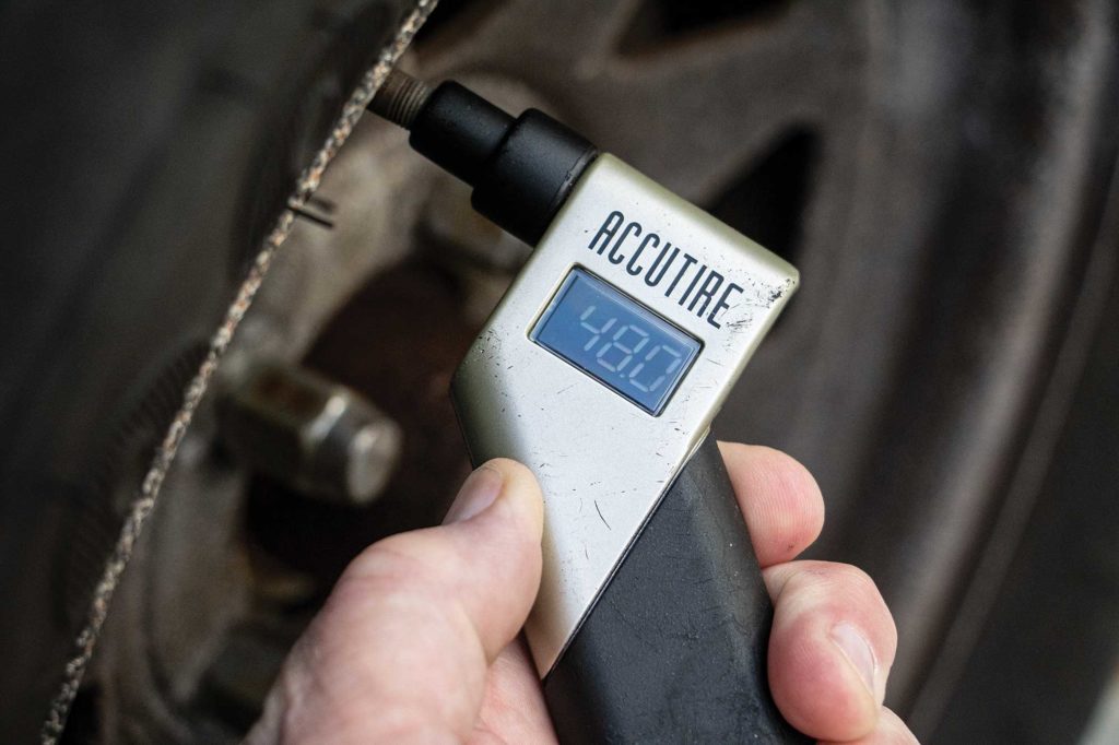 Checking tire air pressure on a boat trailer